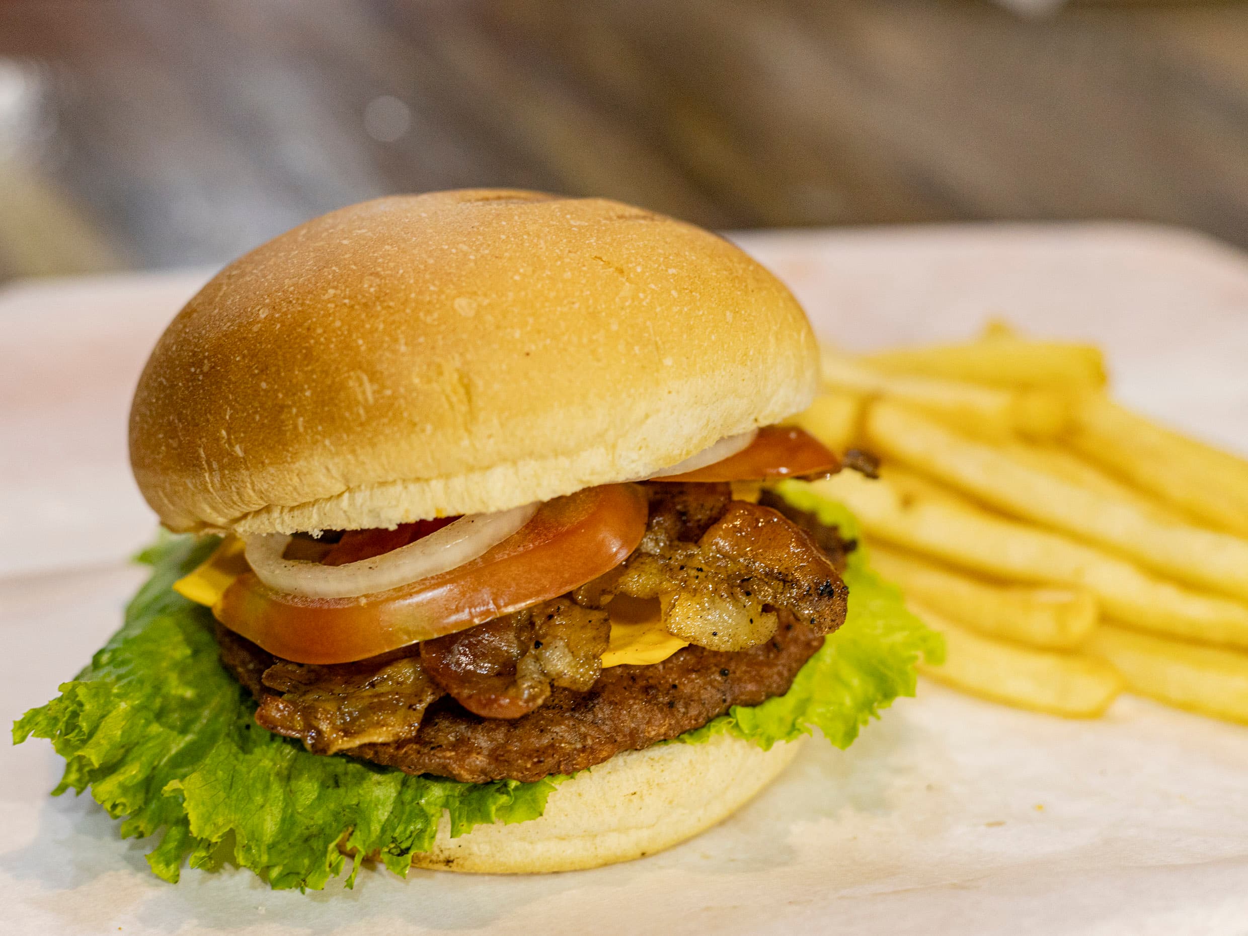 Hamburguesa del dia con Tocino + Papas