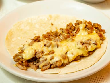 TACO DE BISTEC/COSTILLA/ Ó CHULETA C/QUESO Y HARIN