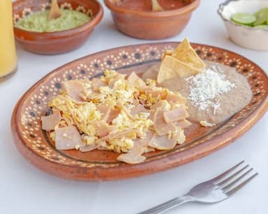 Huevos al Gusto acompañado de frijoles y chilaquil